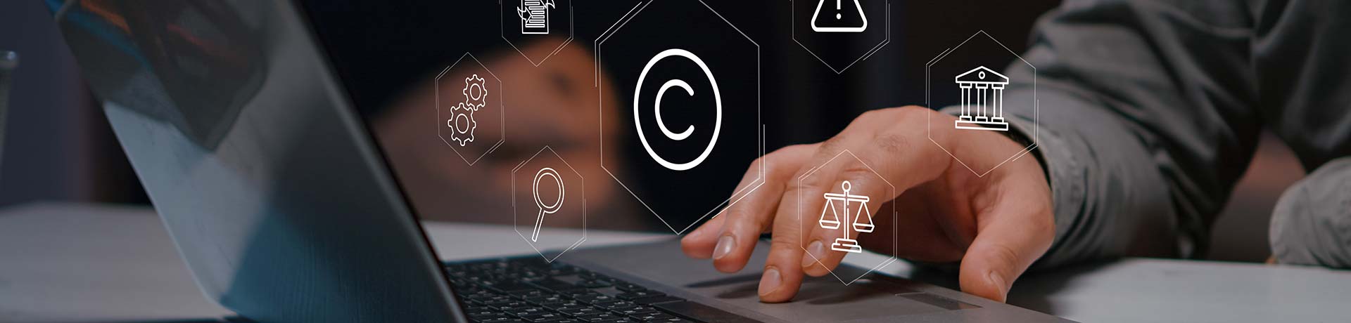 Person typing on a laptop with floating legal icons (copyright, scales, courthouse) representing legal tech.
